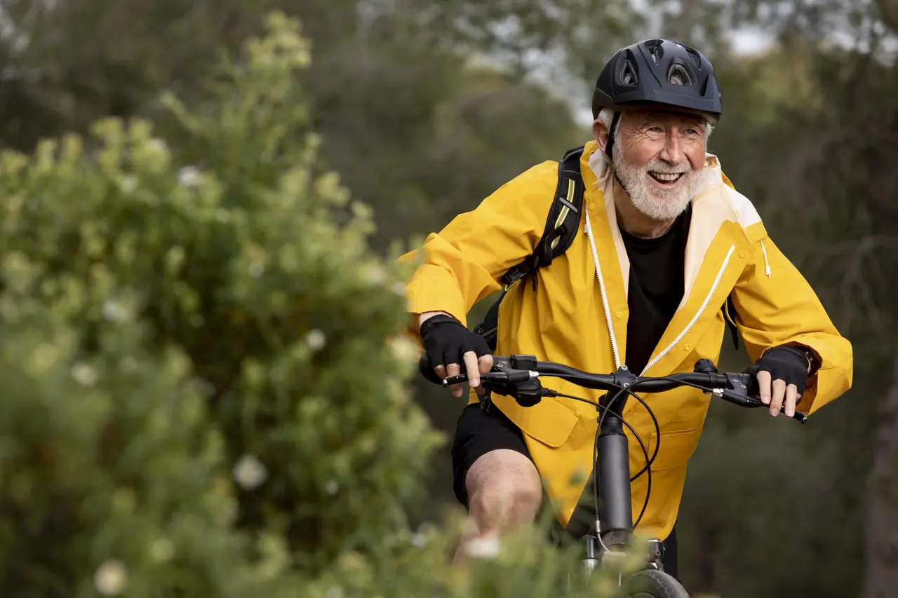 portrait-senior-man-with-bike-mountain-scaled-1